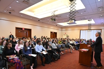 Hartigan Forum attendees seated and Dean Wolfinger at the podium