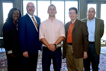 Seth Lazar and St. John's employees pose for a group photo