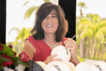 oanne Persico signing a donated volleyball during OSDIA’s 59th Biennial National Convention. Photo courtesy of Robin Haden.