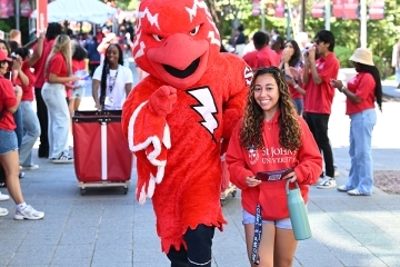Johnny Thunderbird and female student at move in day