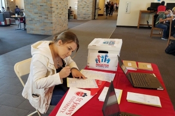female student filling out voter registration form
