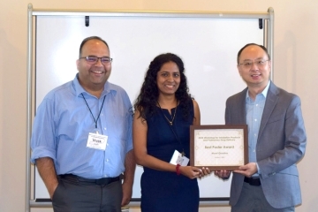 Young woman recieving an award by 2 St. John's Faculty, Left and right of her 
