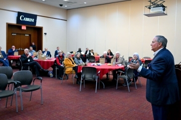 Male speaker talking to a group of people