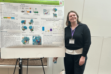 Student in front of a presentation board