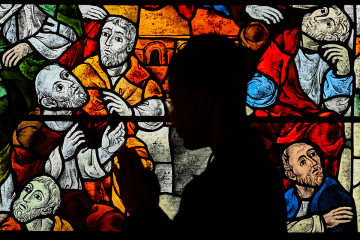 Shadowed Person praying in a church