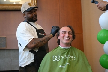 Male student getting his head shaved as part of a St. Baldrick’s Foundation fundraiser on the Queens, NY, campus.