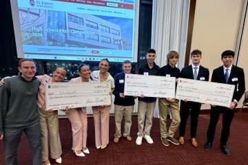 Group of students holding college funded checks 