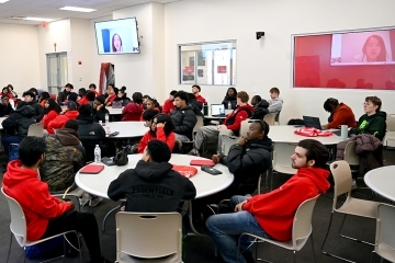 Students sitting at round tables