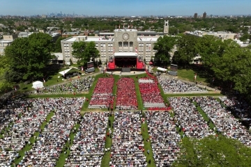 Aerial view of St. John’s University commencement ceremony with graduates and guests gathered on the Great Lawn.