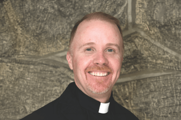 Headshot of Father Fitzgerald wearing clerical attire.