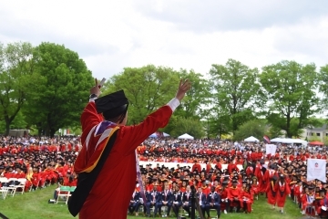 Student walking across commencement stage
