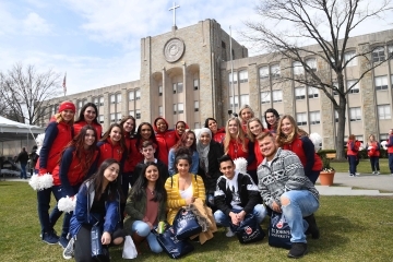 St. John’s Dance Team poses with new students by St. Augustine Hall