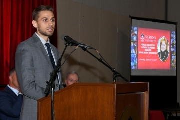 Male student speaking at podium