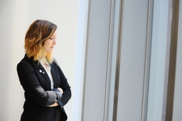 Female student looking out windows