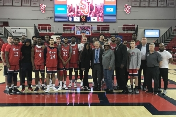 Group shot of students and coaches with Dr Lapchick