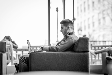 Student working at laptop in lounge