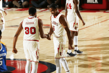 Figueroa shaking hands with Simon at center court