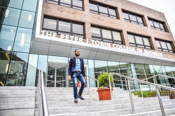 Student on stairs of Tobin