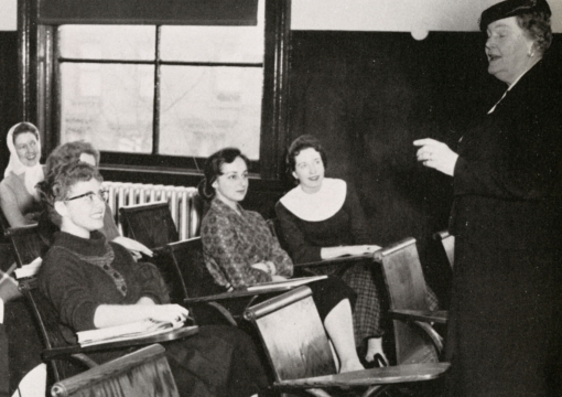 Female faculty member infront of classroom in 1958