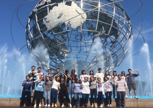 International students in front of the Unisphere in Flushing Meadows