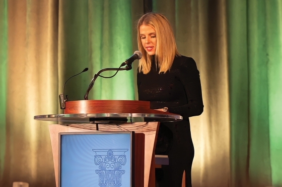 Gina Harrow Standing At Podium
