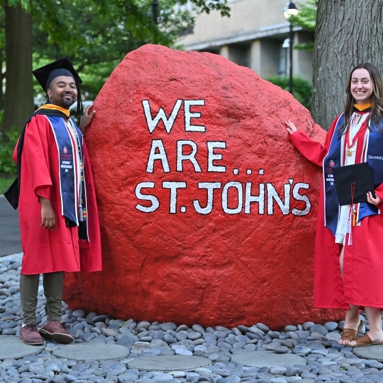 St. John's Graduates in Red Graduation Gown 