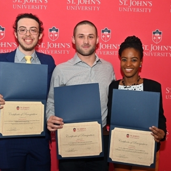 St. John's Students Celebrating their Success Holding an Achievement Award