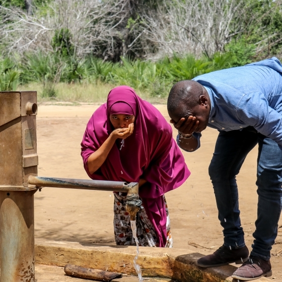 While mapping water points, Zeynab Miski Ahmed, a community data steward n Tana River County, Kenya, shares a moment at a pump with Victor Awuor, UNDP Kenya Head of Solutions Mapping. 