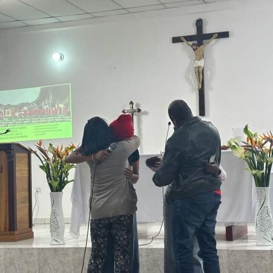 People hugging in a church 