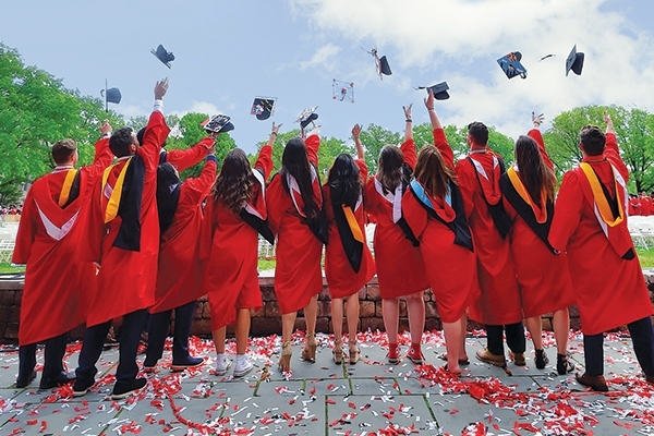 students throwing caps in the air