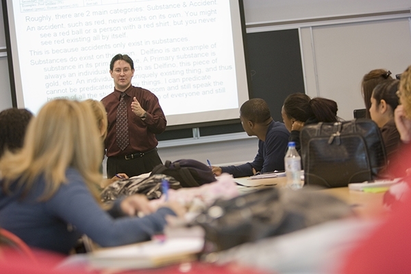 Male teacher instructing students in classroom
