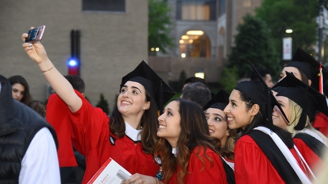 Students taking selfie at graduation 1600x900