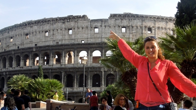 Female student posing infront of coliseum in Rome
