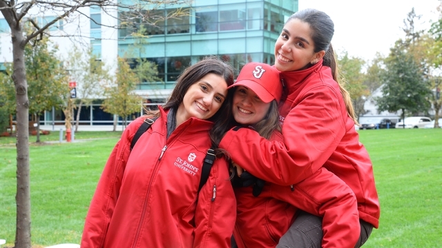 Three students posing for photo on Staten Island campus