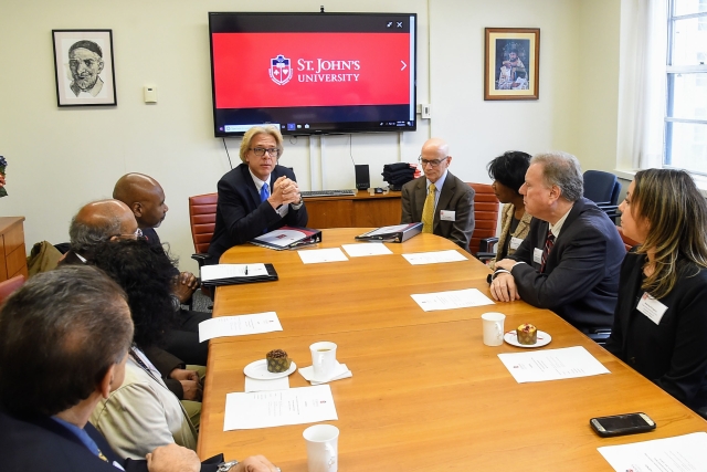 Administrators talking to one another at articulation agreement signing around table