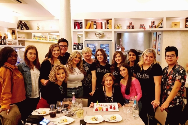 Students posing for photo at dinner table 