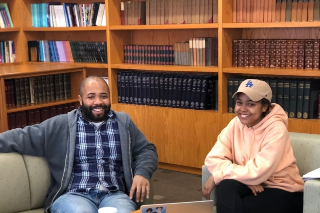 Dr. Lequez Spearman and female student sitting on couch 