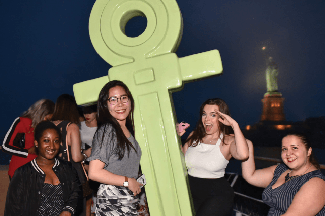 Alumni posing with an anchor at GAHW cruise 