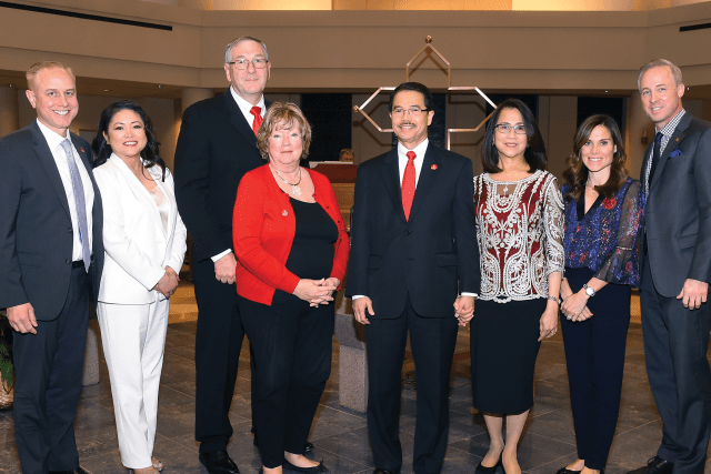 8 Couples posing for photo in church after blessing of the couples
