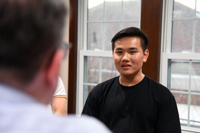 Male interviewing another male at table