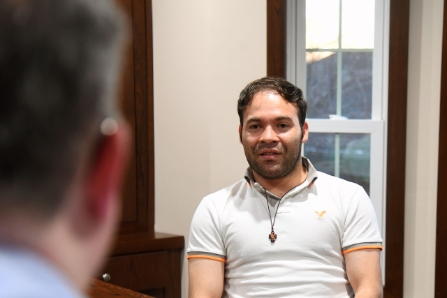 Male interviewing another male at table