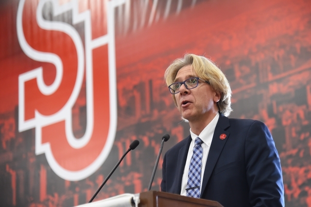 Simon Moller speaking at podium