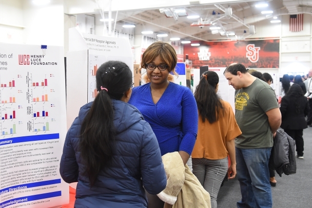 Line of researchers sharing their posters in Taffner Field House
