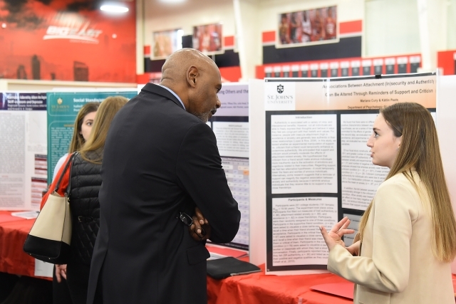 Female student sharing research with male