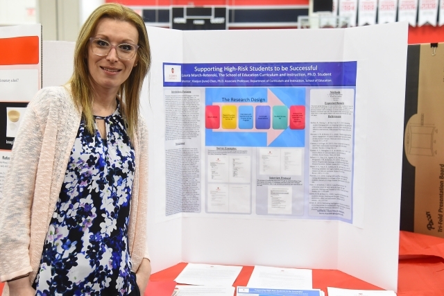 Female student standing infront of poster board