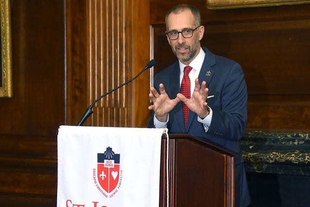 Dean Simons speaking at podium