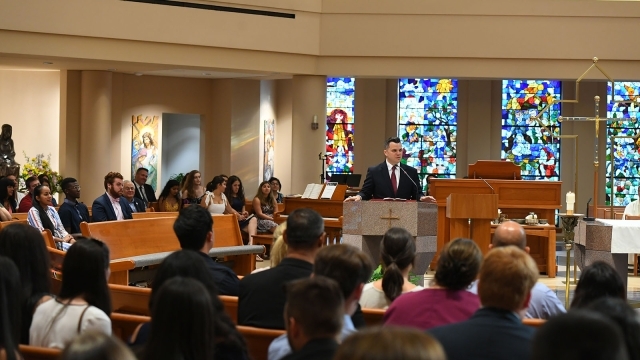 Jimmy Walters speaking at a Mass in St. Thomas More Church