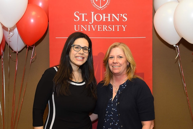 Two female attendees at the VIP reception