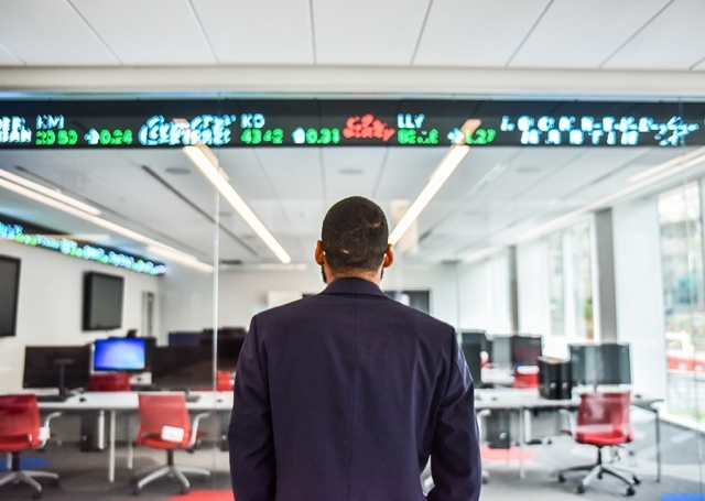 Student looking at ticker in Tobin Lobby