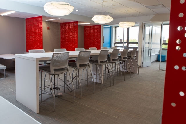 The Peter J Tobin College of Business empty lobby with counter height chairs